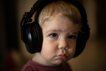 Niño rubio escuchando música con auriculares