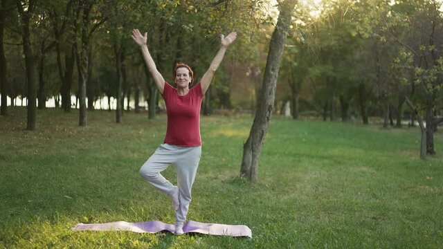 Elderly woman do yoga at the park