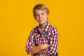 Portrait of smiling confident calm caucasian teen boy student with crossed arms