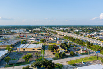 Aerial top view of typical a Houston city Texas shopping center with big parking lot near major 45 interchanges freeway