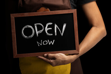 Close up of waitress showing chalkboard with open sign at coffee shop - Powered by Adobe