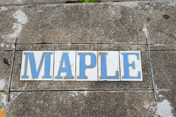 Maple Street Tile Inlay on Sidewalk in Uptown Neighborhood in New Orleans, Louisiana, USA	