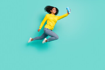 Fototapeta na wymiar Full length body size view of attractive cheerful girl jumping drinking soda isolated over bright teal turquoise color background