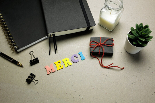 merci (thank you in french language) word made with felt letters on cardboard background