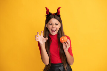 evil child in imp horns. happy halloween. devil kid with pumpkin. trick or treat. - obrazy, fototapety, plakaty