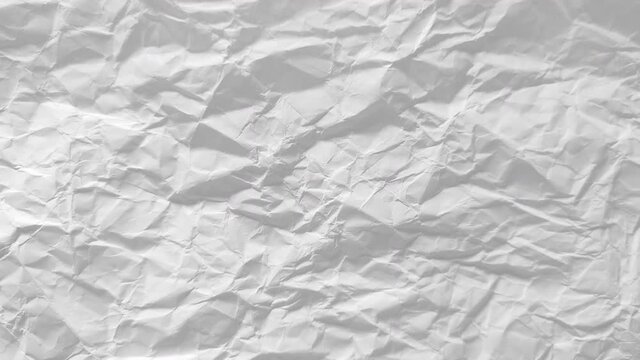 Stop motion animation of white crumpled paper texture background. Blank empty sheet of paper. Space for text. Frame-by-frame stopmotion sequence. Video luma mattes. Seamless looping