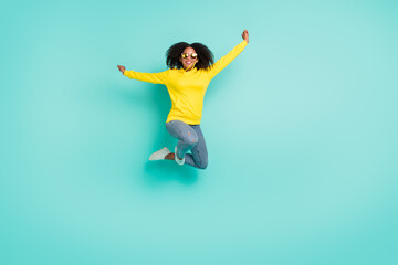Fototapeta na wymiar Full length body size view of nice cheerful wavy-haired girl jumping having fun isolated over bright teal turquoise color background