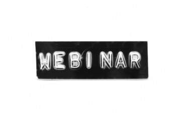 Black color banner that have embossed letter with word webinar on white paper background