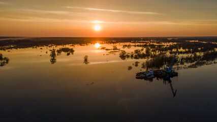 Obraz na płótnie Canvas Aerial atmospheric view on big river. Aerial drone view of river landscape in sunny sunset. Nature concept.
