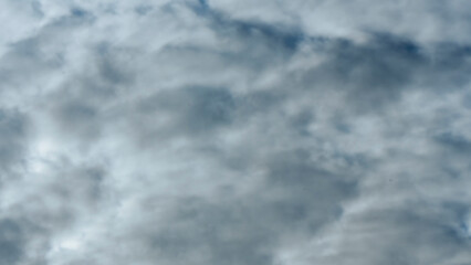Panorama of cloudy gray sky. Dark sky with white clouds. Background for design.