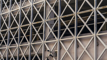 Car parking building with metal grille. Abstract steel surface with copy space. Urban concept.