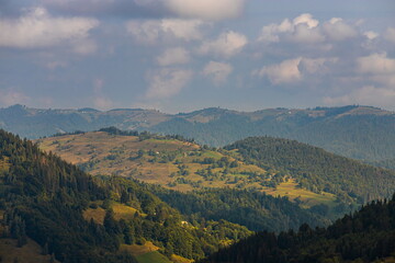 Fototapeta na wymiar mountain slopes in the Ukrainian Carpathians. mountain tops and forests on a background of blue sky