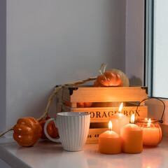 Preparing your home for Halloween. A wooden pumpkin box, faux pumpkin garland, orange candles, a...