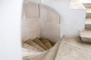 White spiral staircase leading to the first floor of the church