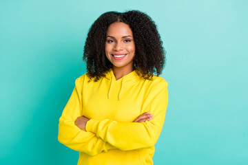 Fototapeta premium Photo portrait woman smiling confident crossed hands isolated vivid teal color background