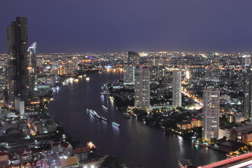 Fototapeta na wymiar The Cityscape, the Skyscraper and the Chao Phraya River of Bangkok Thailand in the Night
