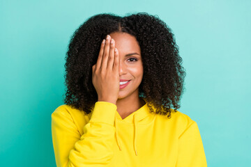 Photo portrait curly woman shut eye with hand in yellow outfit isolated bright teal color background