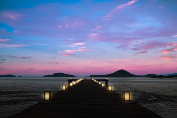 twilight background beautiful pier decorated with lanterns in silent sea at the sunrise or sunset