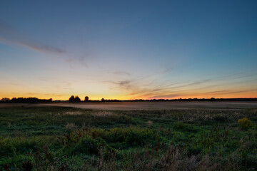 Obraz na płótnie Canvas Fog over the meadow, view after sunset
