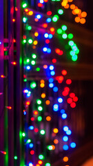 Fototapeta na wymiar Christmas garlands glow at night with a beautiful bokeh for design