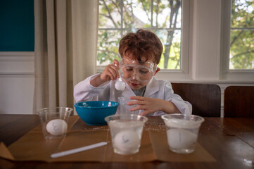 Young scientist concentrating on an experiment wearing lab coat
