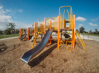 Empty play structure with slides and climbers on a playground.
