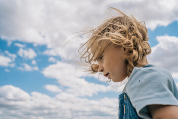 Portrait of little boy against the blue sky