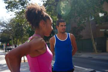 Obraz premium Young ethnic couple working out together outdoors