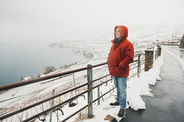 Outdoor portrait of middle age man enjoying winter landscape of snowy vinyards © annanahabed