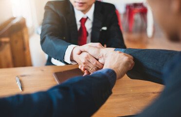 Teamwork colleagues business handshake after meeting. Businessman shaking hands to seal a deal with his partner.