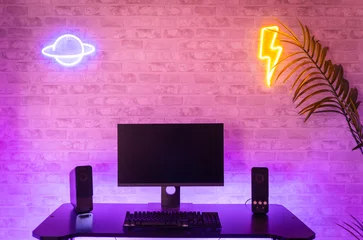 Fotobehang Gaming Computer gamer workspace with black screen monitor with neons and colorful lights. Gamer Rig.  © deliris