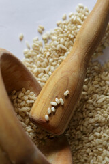 Arroz integral sobre papel blanco al lado de un mortero de madera 