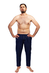A frustrated man stands in trousers with a naked torso. Unsportsmanlike figure. Full height....