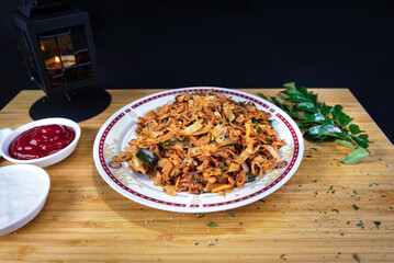 Traditional Sri Lankan kottu roti in wooden background