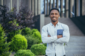 Portrait of a young cheerful African American man looking at the camera, smiling and rejoicing