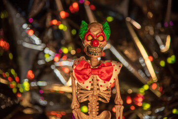 Creepy plastic clown skeleton with crazy bokeh background