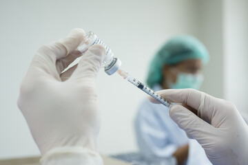 Doctor's hand holding syringe and bottle for vaccination.Vaccine for protection Coronavirus...
