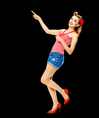 Full body photo of happy excited smiling woman pointing at something. Blond girl in pin up style,...