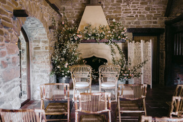 Rustic chair in a living room with fireplace decorated with floral arrangements