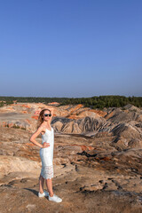 A beautiful woman on the background of landscape.Top view of the quarry