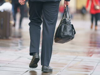 Man on the Moscow city street in the city center. He holding leather bag. Moving ahead. Lifestyle...