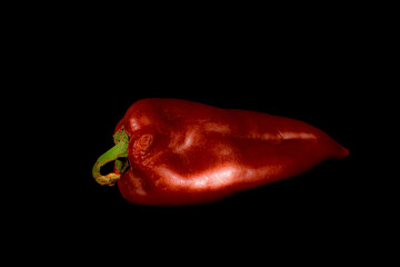 Red bell pepper on a black background.