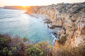 Stunning view over Praia do Camilo in Lagos, Algarve Portugal during the sunrise. Rocks, cliffs and formations in the ocean. Natural treasure. Portugal
