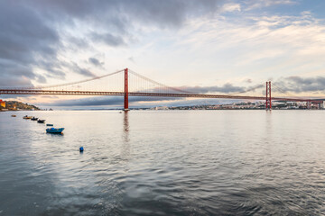 Fototapeta na wymiar the 25 de Abril suspension bridge over Tagus river in Lisbon, Portugal at sunrise