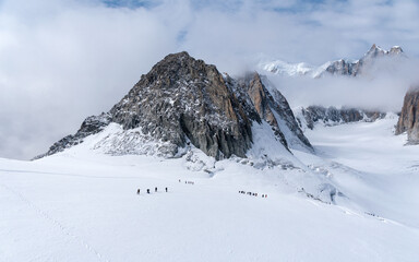 Fototapeta na wymiar The Glacier du Geant on the Mont Blanc massif, with a group of mountaineers