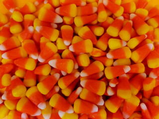 Candy corn background close-up top view stock images. Popular halloween candy frame images. Pile of candy corn photo