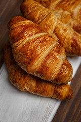 Croissant on wooden board - freshly baked pastry