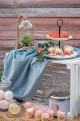 Banquet dessert table decorated in a rustic style decorated with plates, cutlery, glasses, candles and flower arrangements. Top view. Copy, empty space for text