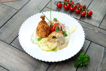 Chicken Kiev in a plate. on a wooden background.