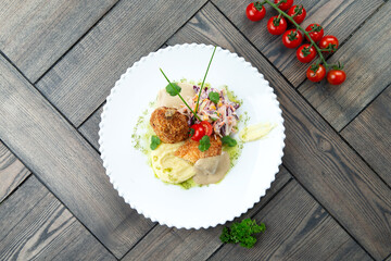Chicken Kiev in a plate. on a wooden background.